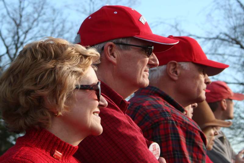 a group of people in red hats