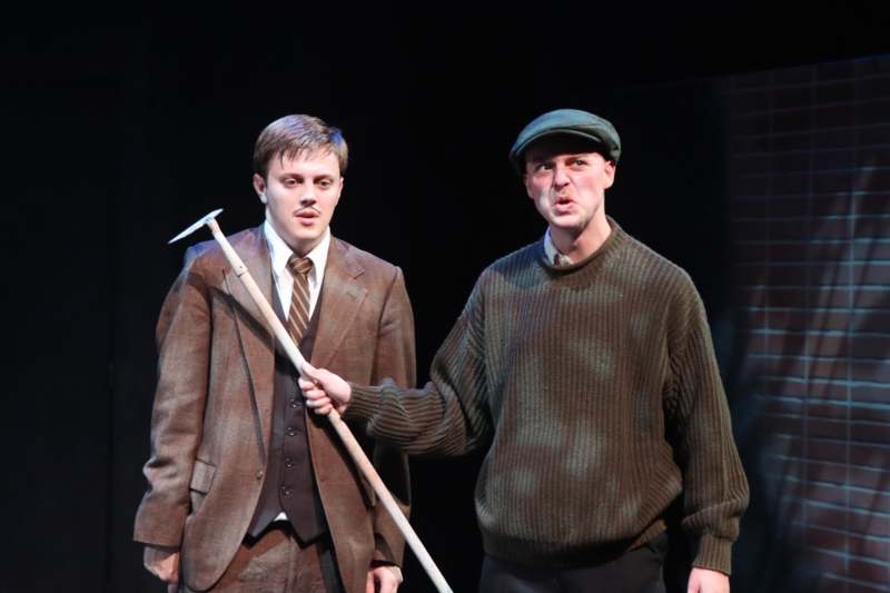 a man holding a pick and a man holding a stick