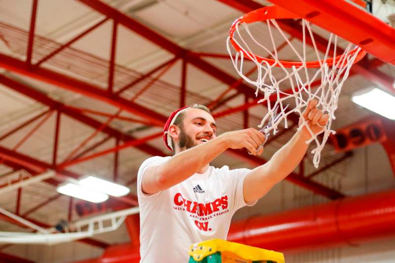 a man holding a basketball hoop
