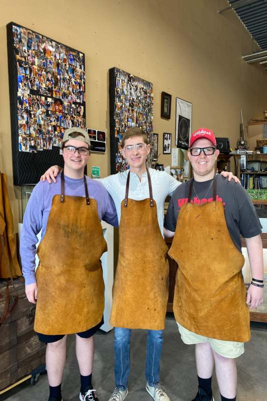 a group of men wearing aprons