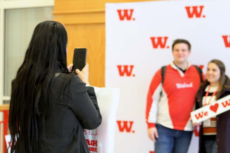 a woman taking a picture of a man