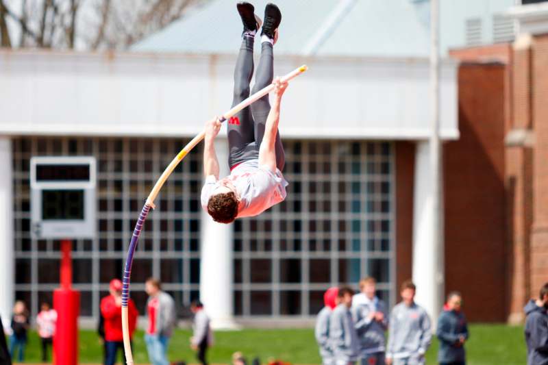 a man jumping over a pole