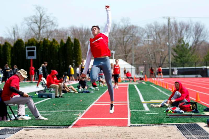 a man jumping in the air on a track