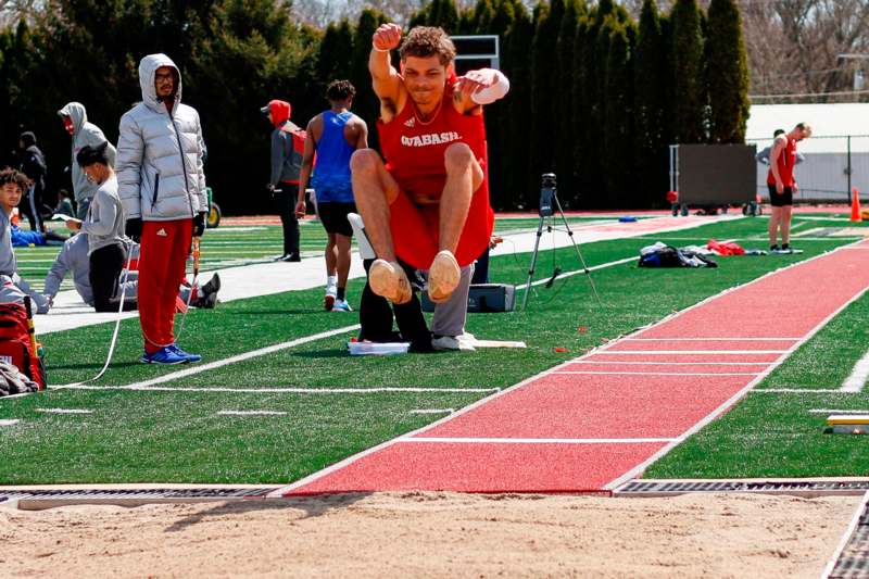a man jumping in the air on a track