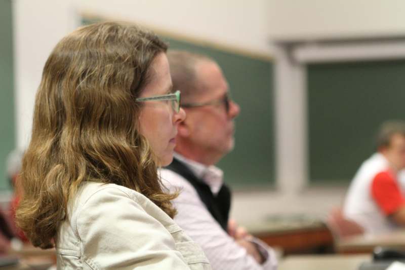 a man and woman sitting in a classroom