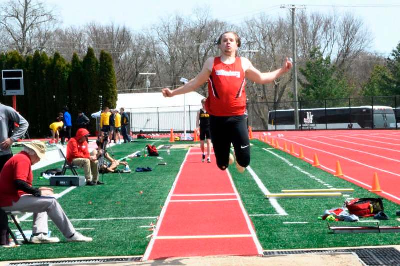 a person jumping in the air on a track