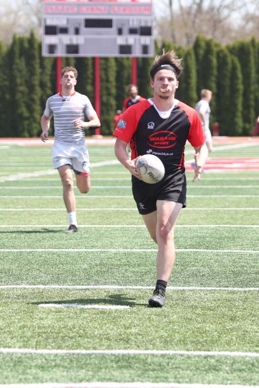 a man running on a field with a ball