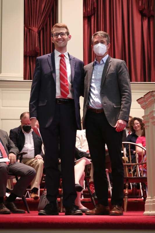 two men wearing suits and masks