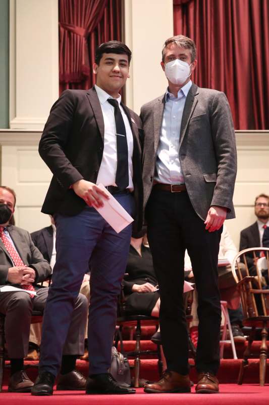 two men wearing masks and standing on a stage