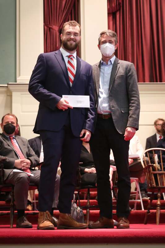 two men wearing masks and standing on a stage