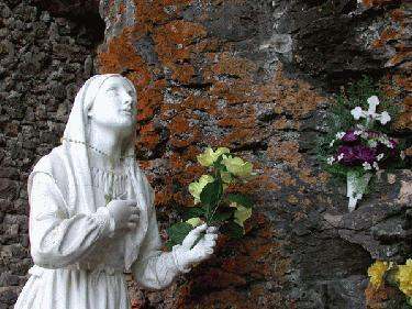 a statue of a woman holding flowers