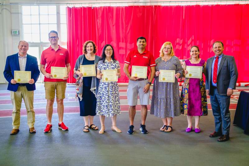 a group of people holding certificates
