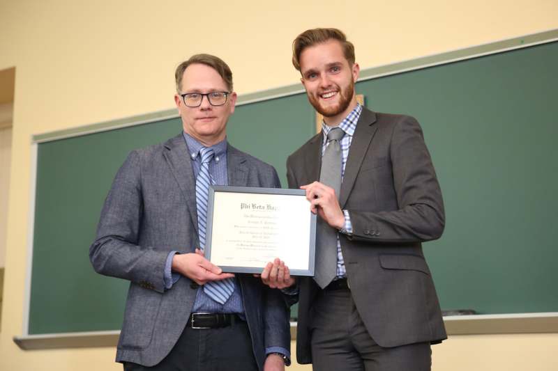 two men holding a certificate