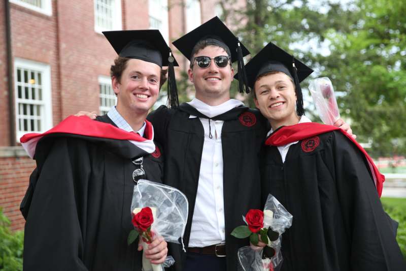 a group of men in graduation gowns and caps