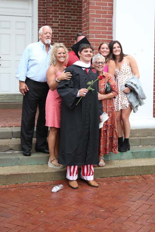a man in a graduation gown with a group of people