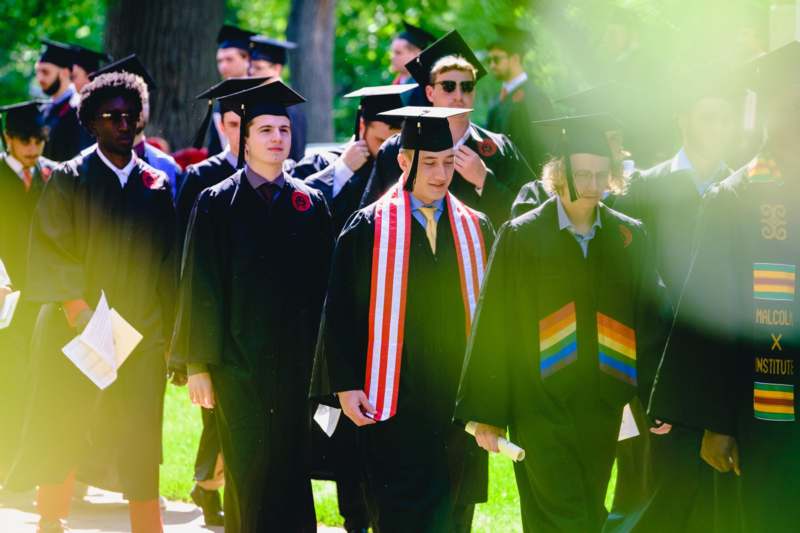 a group of people in graduation gowns and caps