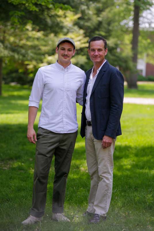 two men standing in a grassy area