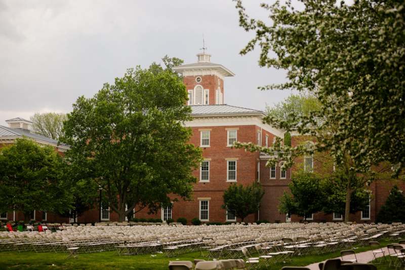 a large brick building with rows of chairs