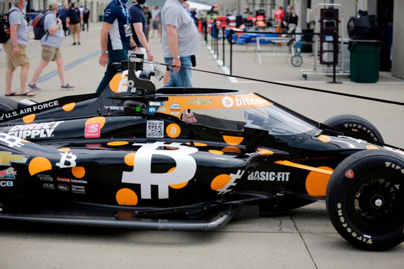 a race car with a bitcoin symbol on it