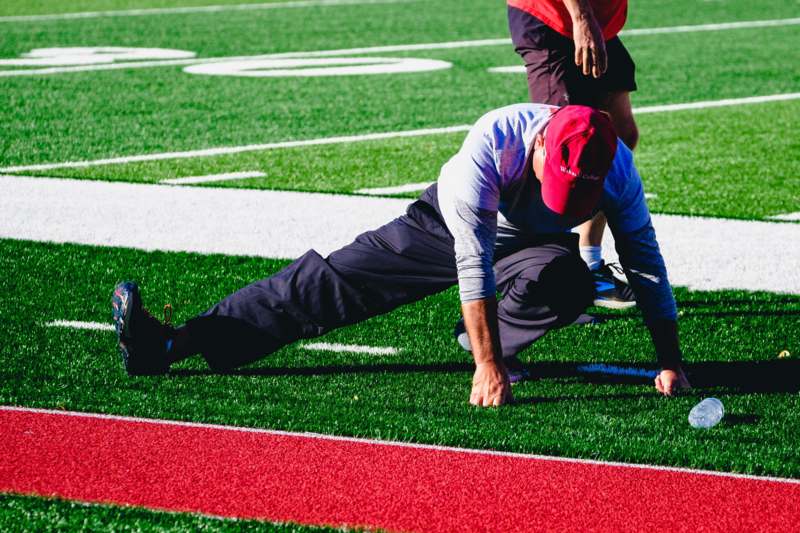 a man stretching on a football field