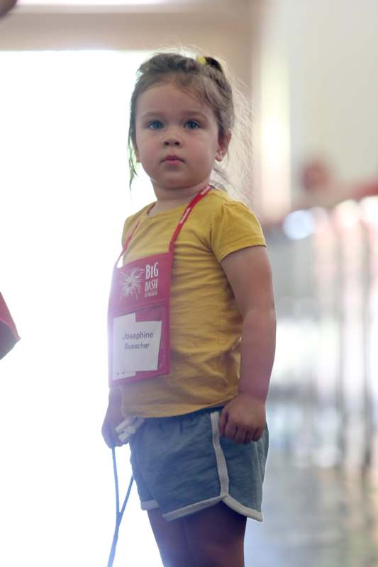 a young girl wearing a name tag