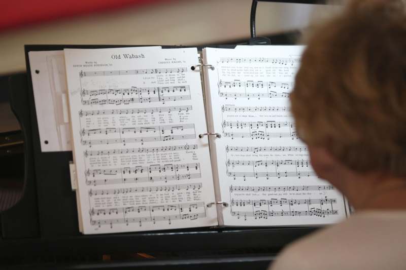 a person looking at a sheet music book