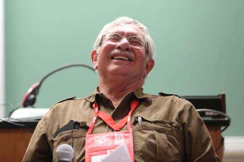 a man laughing with a microphone