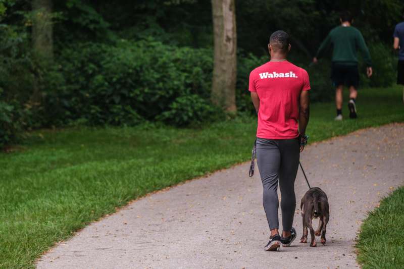 a man walking a dog on a path