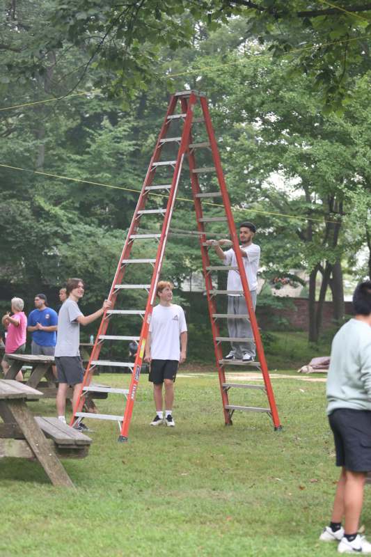 a group of people standing on a ladder