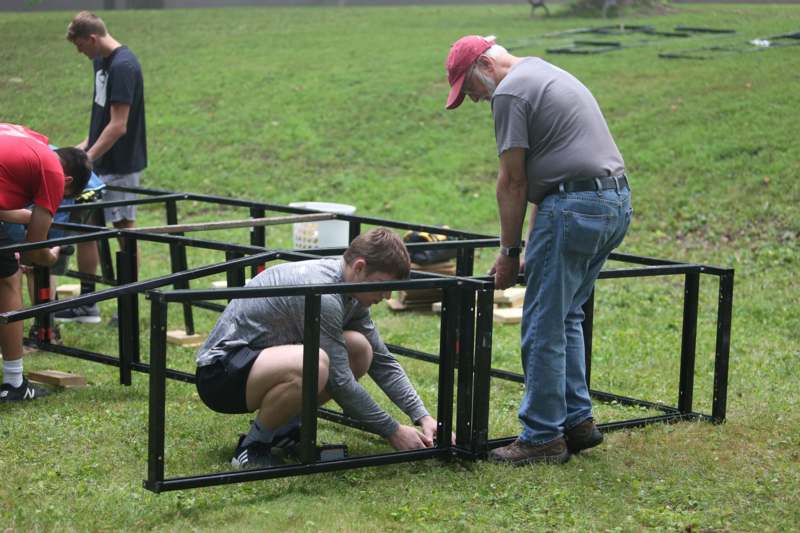 a man and boy building a structure