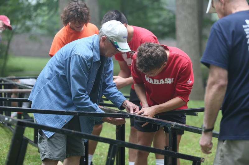 a group of people working on a metal railing