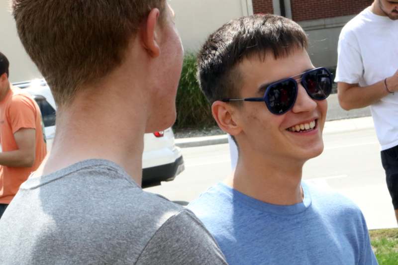 a man wearing sunglasses and smiling