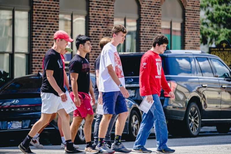a group of men walking on the street