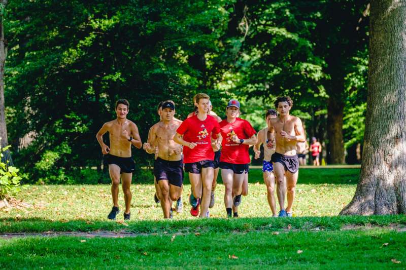 a group of people running in a park