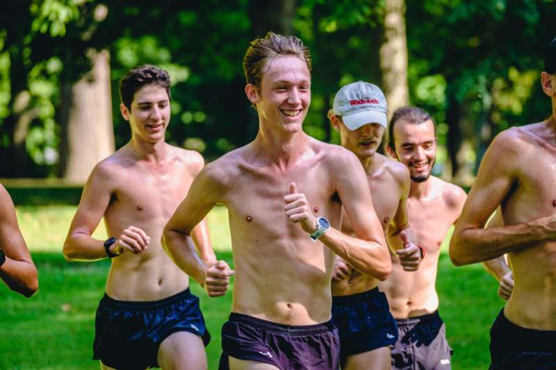a group of men running in a park