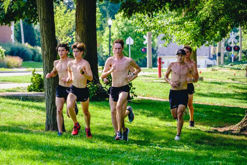 a group of men running in a park