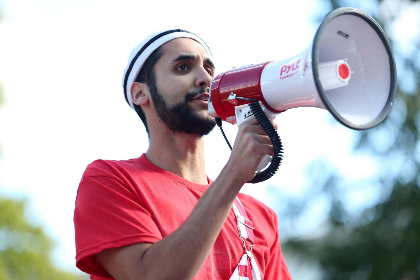 a man with a beard speaking into a megaphone