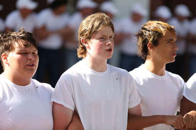 a group of young men in white shirts