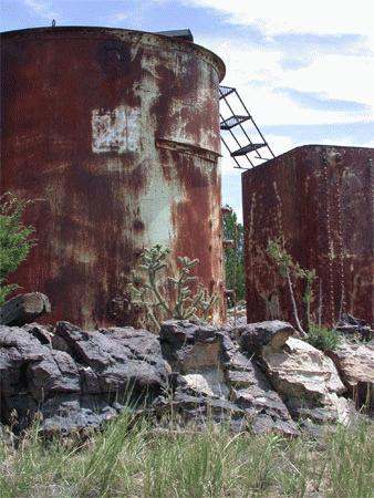a rusty metal tanks with a ladder