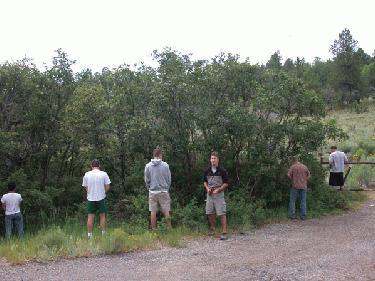 a group of men standing on a road