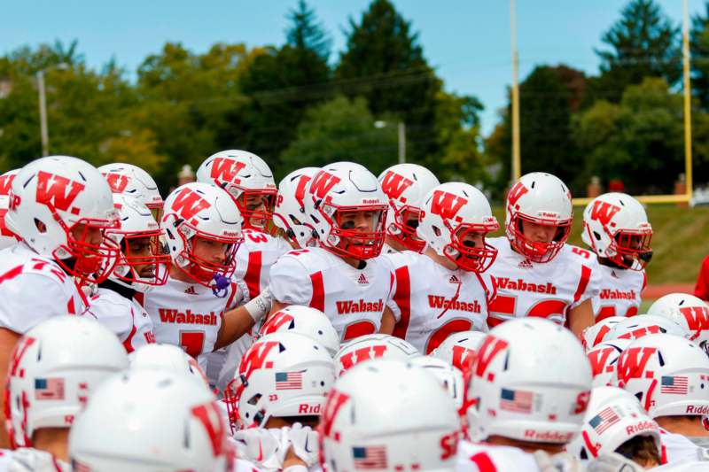 a group of football players in white and red uniforms