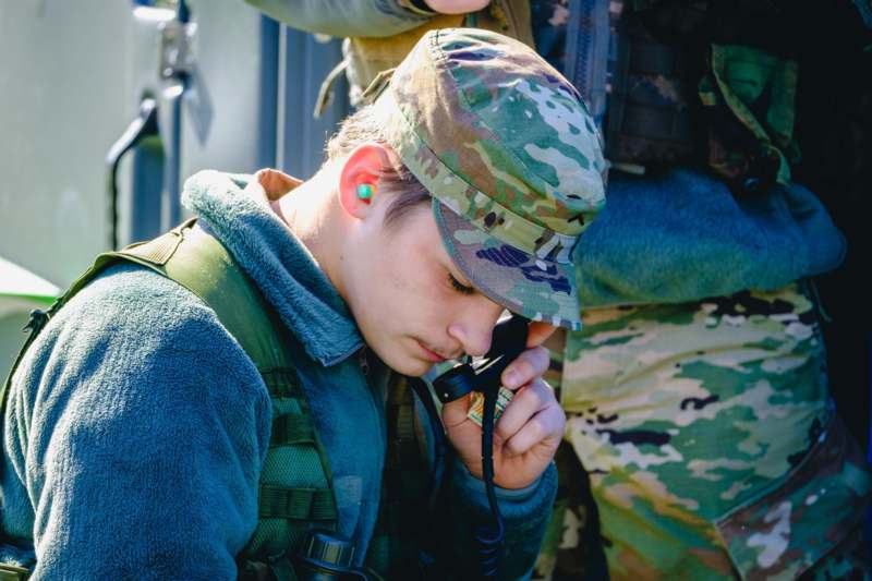 a man in military uniform using a walkie talkie
