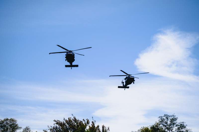 two helicopters flying in the sky