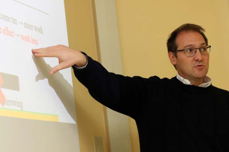 a man pointing at a projector screen