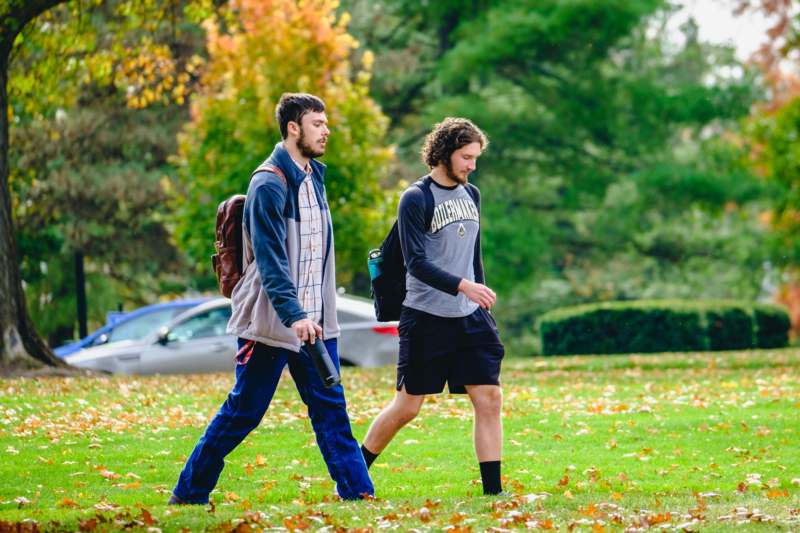 two men walking in a park