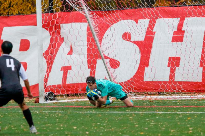 a man diving into a goal