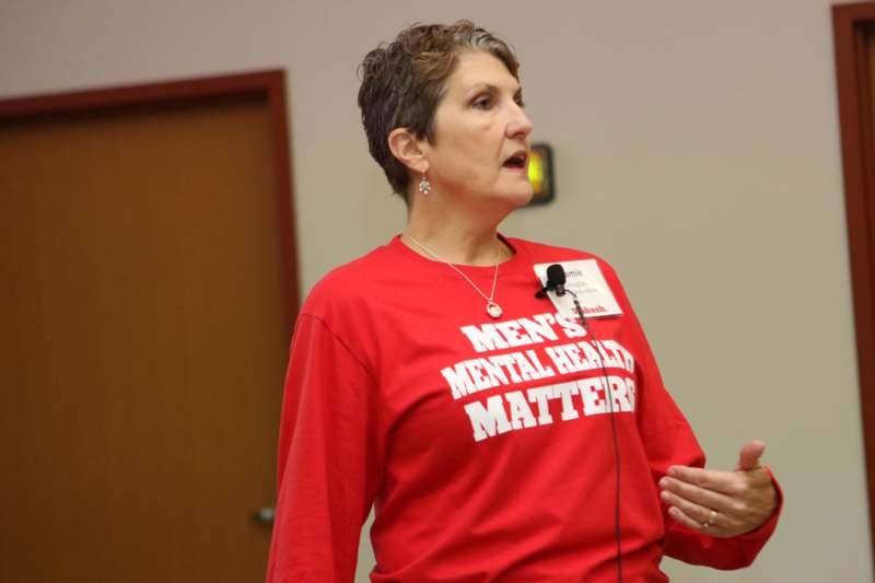a woman speaking to a microphone