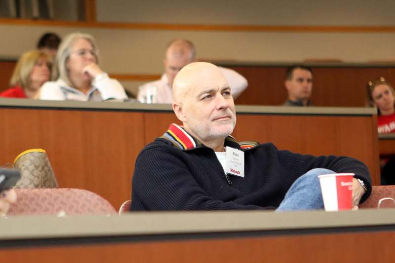 a man sitting in a lecture hall