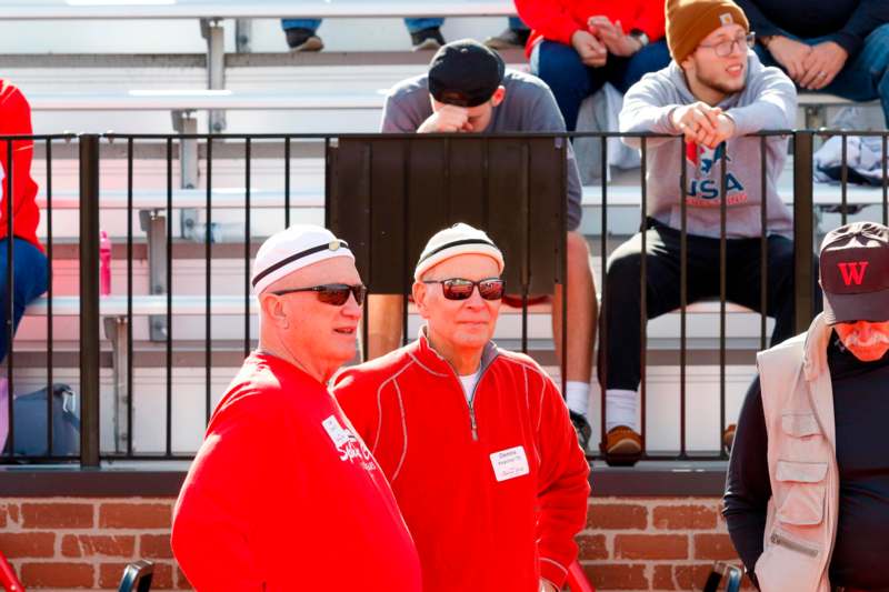 a group of men in red shirts and hats