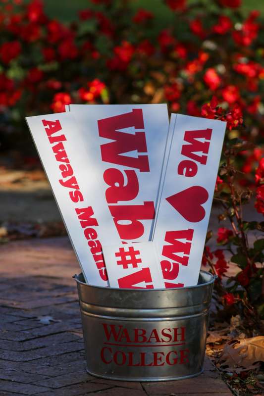 a bucket of signs with red text